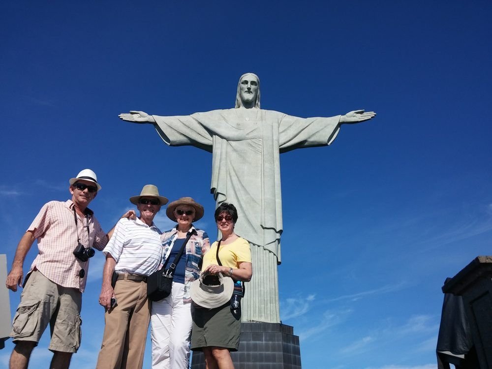 Guests posing with Christ the Redeemer behind them