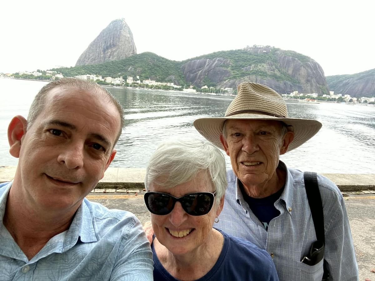 Marcio with guests by the bay, Sugarloaf in the background